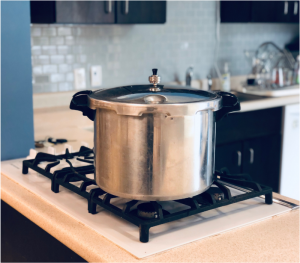 pressure canner on the stove top in a kitchen