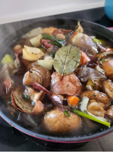 Vegetable stock cooking on a stove.