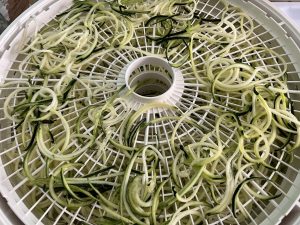 Zoodles in a dehydrator before being dried.