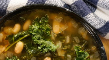 Kale and white bean soup in a bowl.