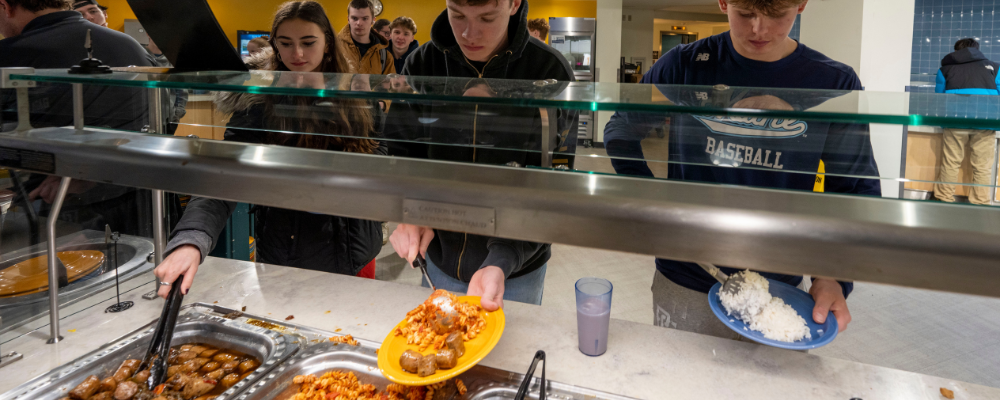 College students getting food at the dining hall.