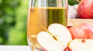 Apples with apple juice in a cup.