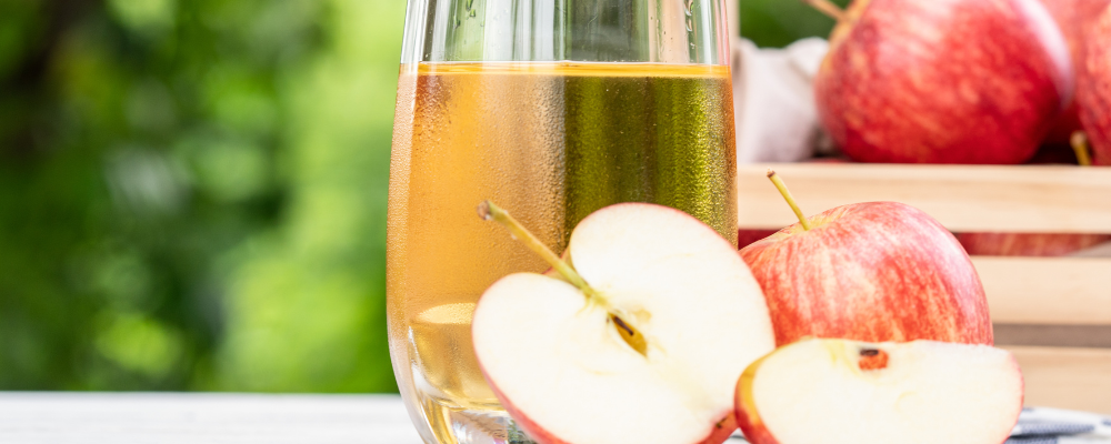 Apples with apple juice in a cup.