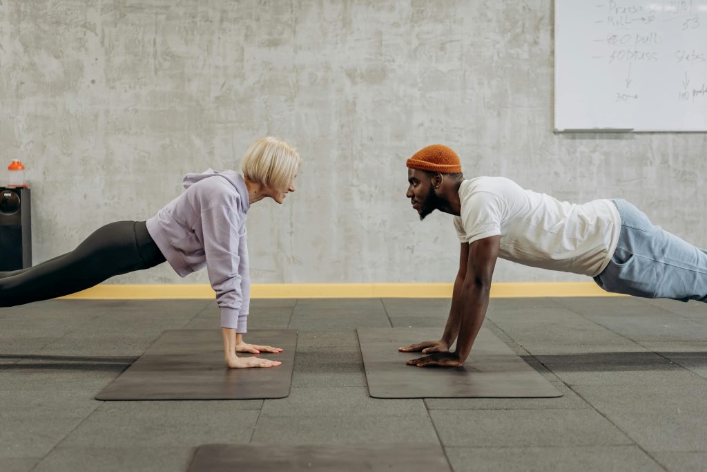 Two people doing a plank hold.