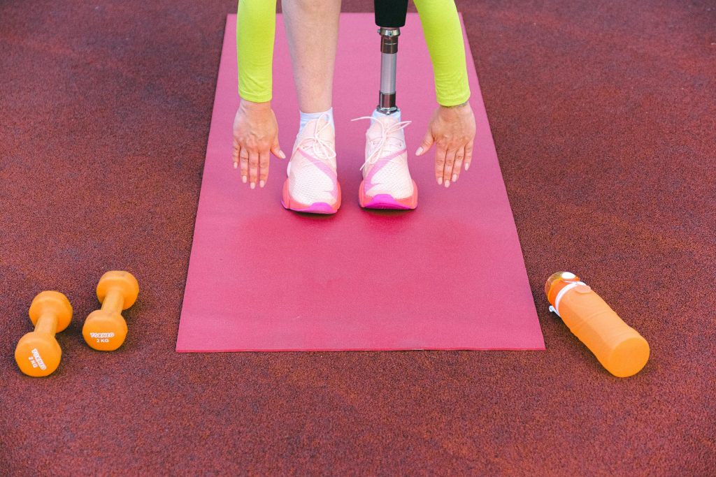 A person on an exercise mat with weights.