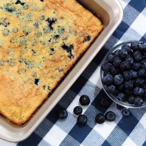 blueberry cobbler next to a bowl of blueberries