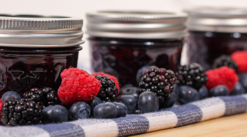 Jars of jam with fruit.