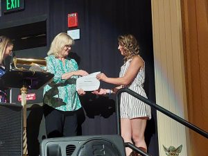 4-Her receiving a scholarship