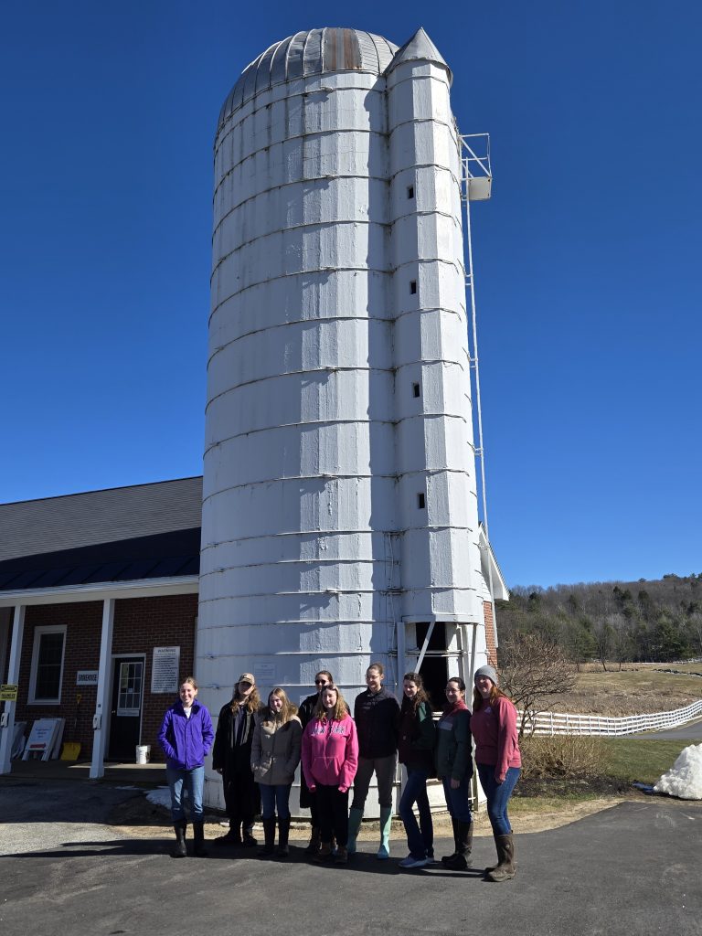 Ag Ambassadors in front of the Education Building and Silo