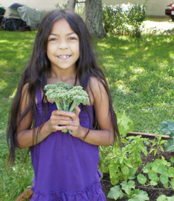 KCG participant harvests her first ever home grown Broccoli