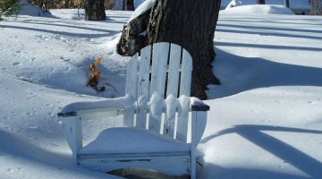 snow-covered Adirondack chair
