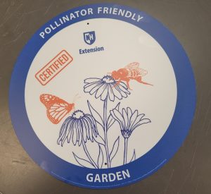 Image of UNH Extension Pollinator Friendly Garden sign - circular sign with drawn image of flowers, a bee, and a butterfly