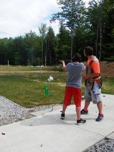 Camper & Instructor sporting clay shooting