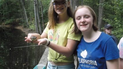Campers holding a frog