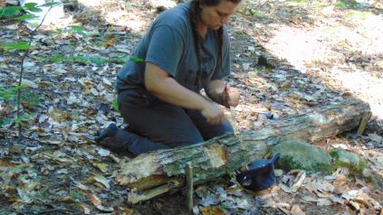 Camper makes wood shavings for kindling