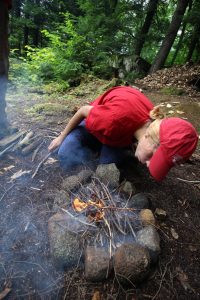 Camper building a campfire