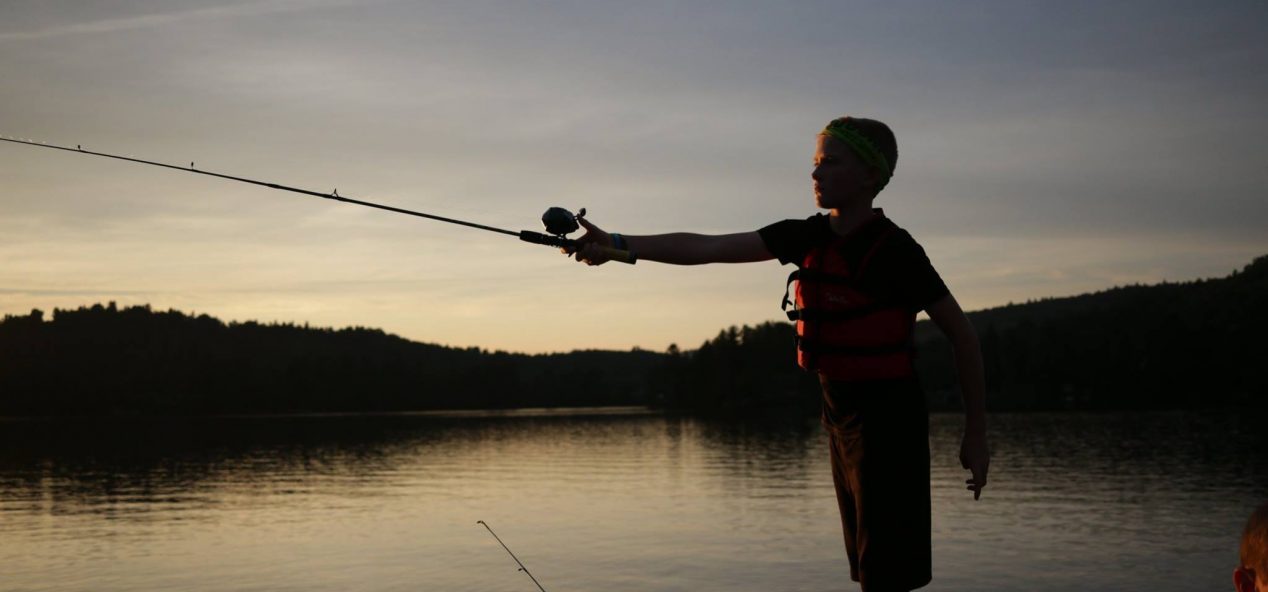 Image of camper fishing at dusk