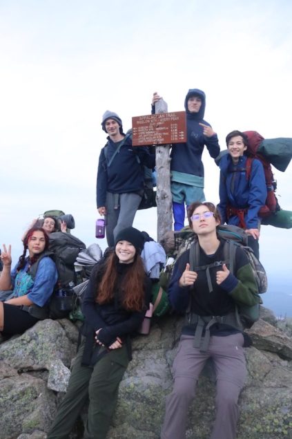 Teens at the top of a mountain