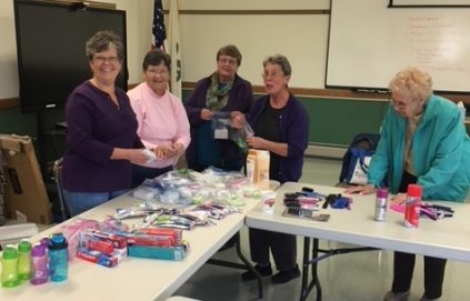 Homemakers filling bags to donate necessities to others.