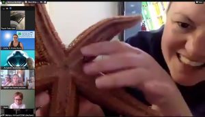 Workshop leader showing a starfish to virtual learners.