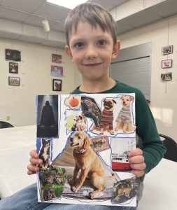 Youth holding up his vision board for 2024, filled with images of dogs