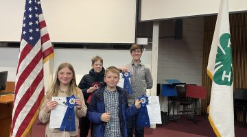 4 youth holding up their ribbons after State 4-H Public Speaking Tournament