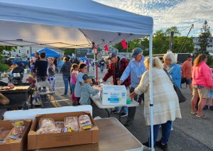 Horse of Course youth helping to take orders and deliver food at their hot dog fundraiser.