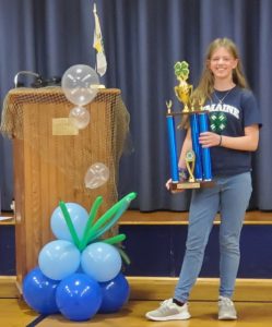 Alexis M standing with her Dwight Sargent Citizenship Award trophy