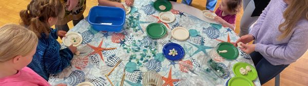 Overhead shot of several youth molding salt dough on a table