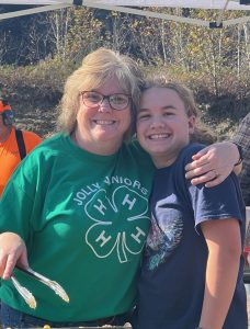 Club leader, Brenda, and a 4-H youth side hugging.