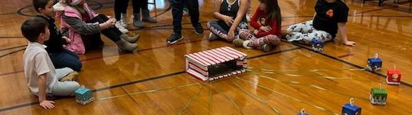 Youth gathered around a pile of presents