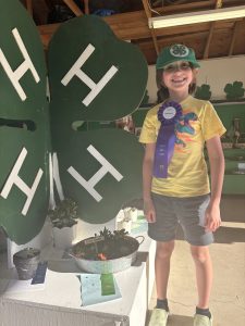 Youth celebrating their Best Project Award with their dino garden.