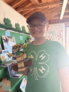 Youth showing off his lego creation that looks just like him