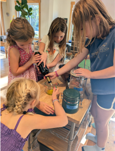Youth working as a group to make tomato sauce.
