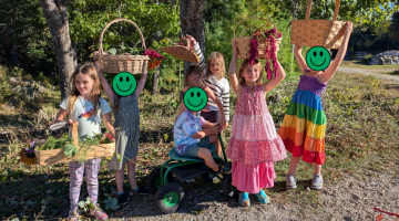 Youth holding flowers they picked and baskets.