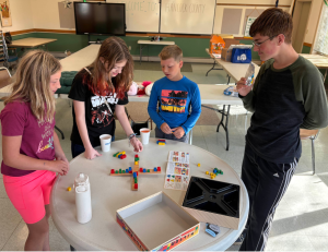 Youth gathered to play a balancing game while chatting.