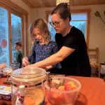 Youth and leader cutting apples.