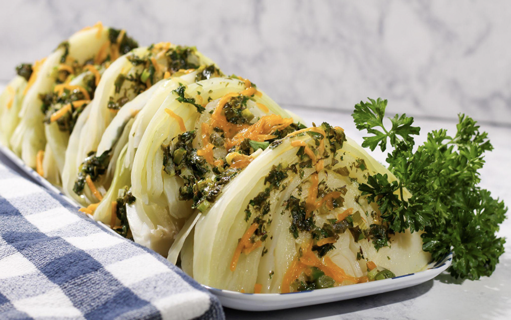 a prepared dish of cabbage with herb butter