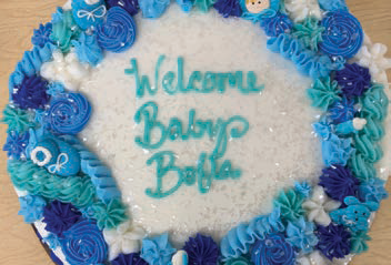 a decorated cake to celebrate a baby's arrival