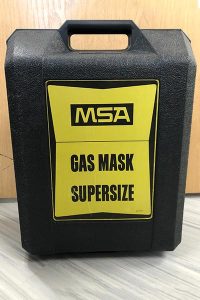 a respirator storage box with a label that reads 'gas mask supersize'