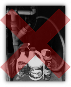 Insecticides and disinfectants under a sink that shows signs of having leaked. A red X overlays the image to demonstrate this is a poor storage area.