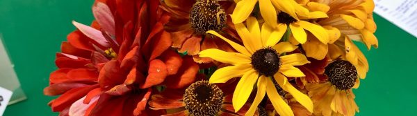 flower arrangement with orange and yellow blooms