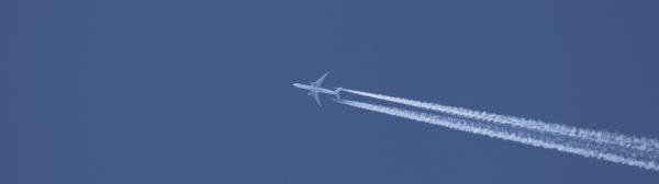 Jet in flight with contrail