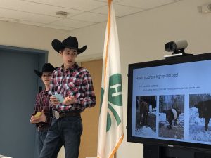 2 4-H members in cowboy hats deliver a speech