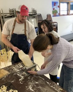 4-H members learning to roll fresh pasta
