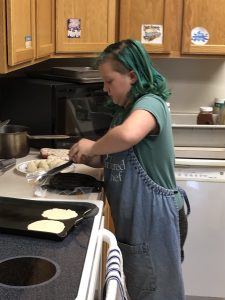 girl using a tortilla press