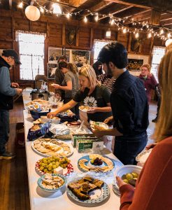 buffet table with people choosing food