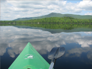 view from inside a kayak, looking for the resident loon pair while kayaking on Sturtevant Pond.