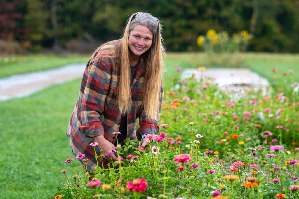 person cutting flowers at Thistle Moon Farm
