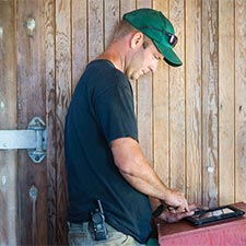 Farmer using a laptop in his barn